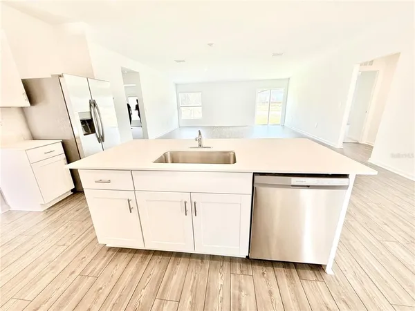 a kitchen with stainless steel appliances a refrigerator stove microwave and sink