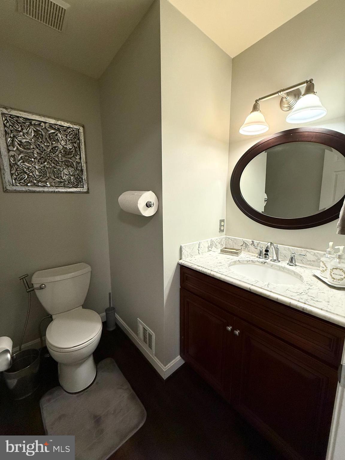 6421 Spring Lake Drive Burke, VA 22015 - Photo 25 of 65 a bathroom with a toilet sink and mirror