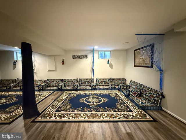 a view of a workspace with furniture and wooden floor