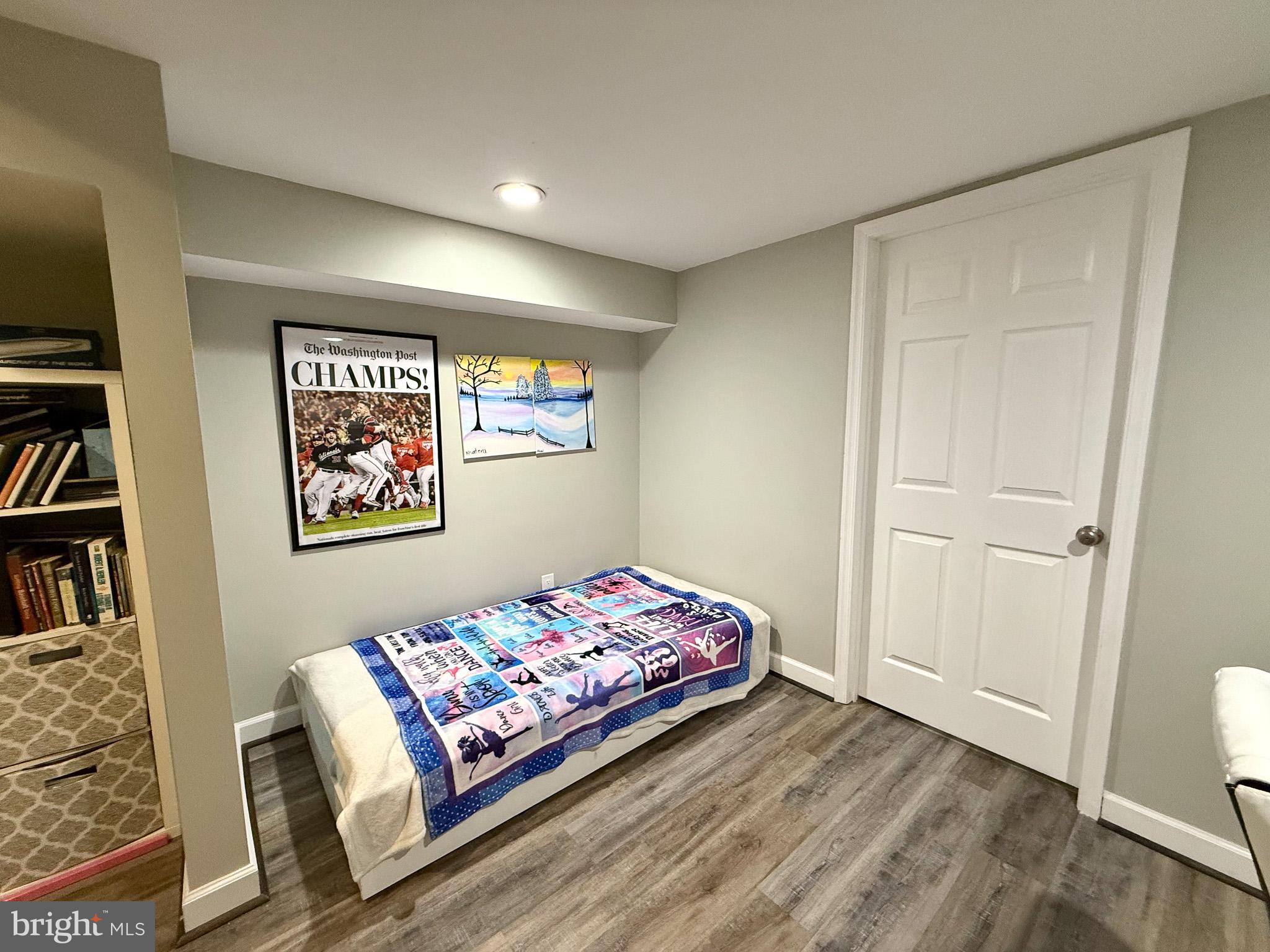6421 Spring Lake Drive Burke, VA 22015 - Photo 36 of 65 a bedroom with a bed and a book shelf