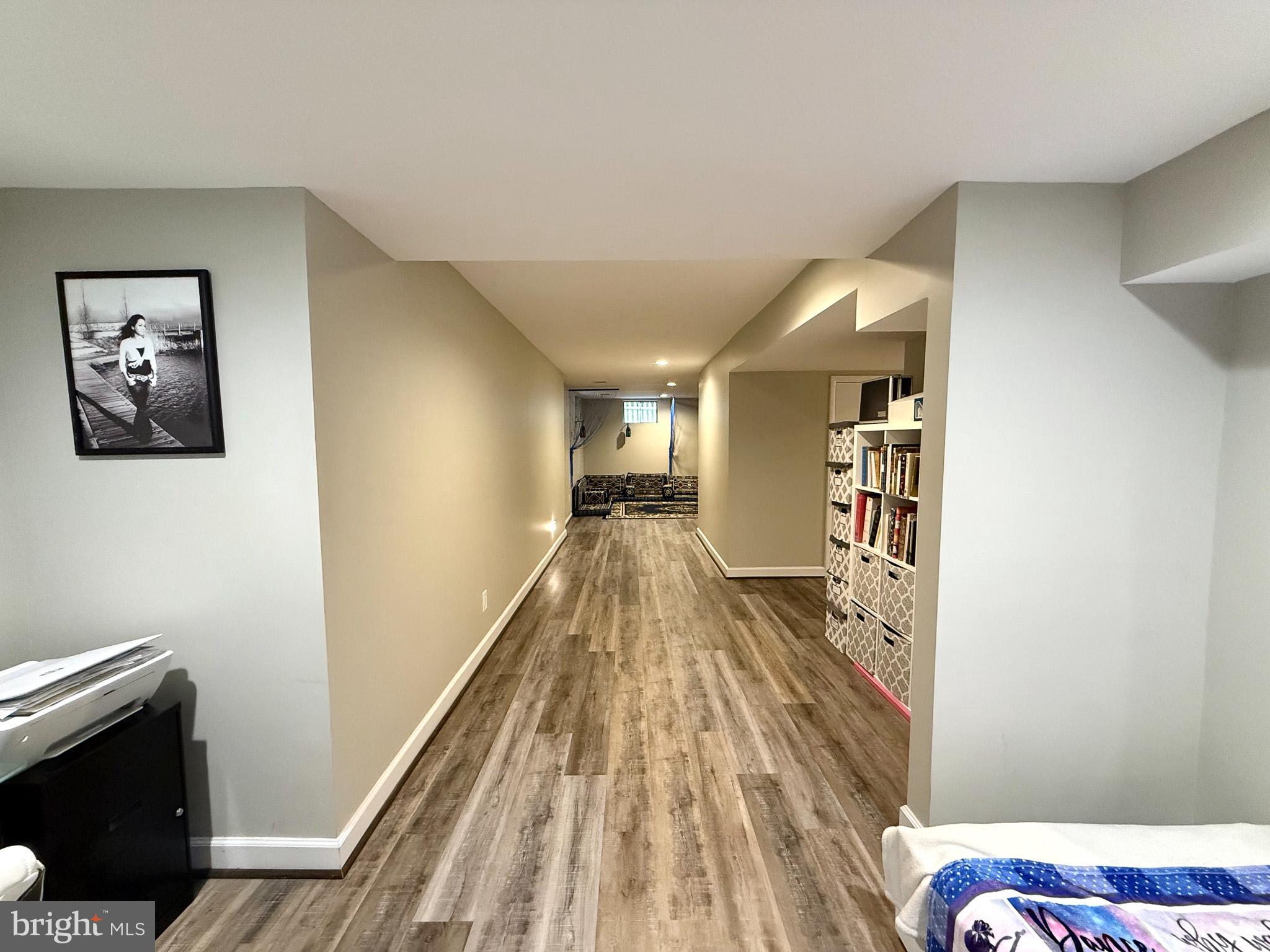 6421 Spring Lake Drive Burke, VA 22015 - Photo 39 of 65 a view of a hallway with wooden floor and staircase