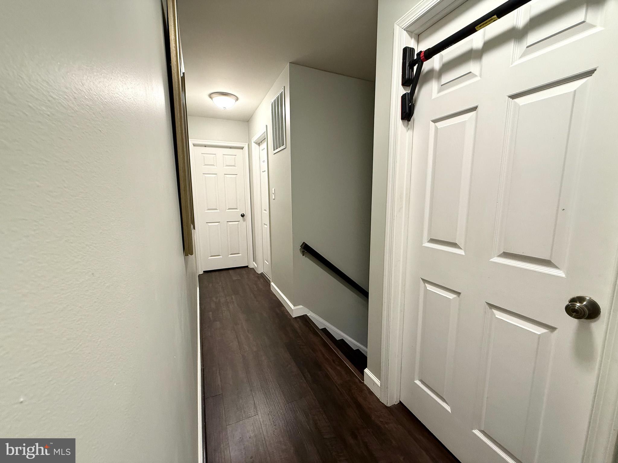 6421 Spring Lake Drive Burke, VA 22015 - Photo 41 of 65 a view of a hallway with wooden floor and staircase