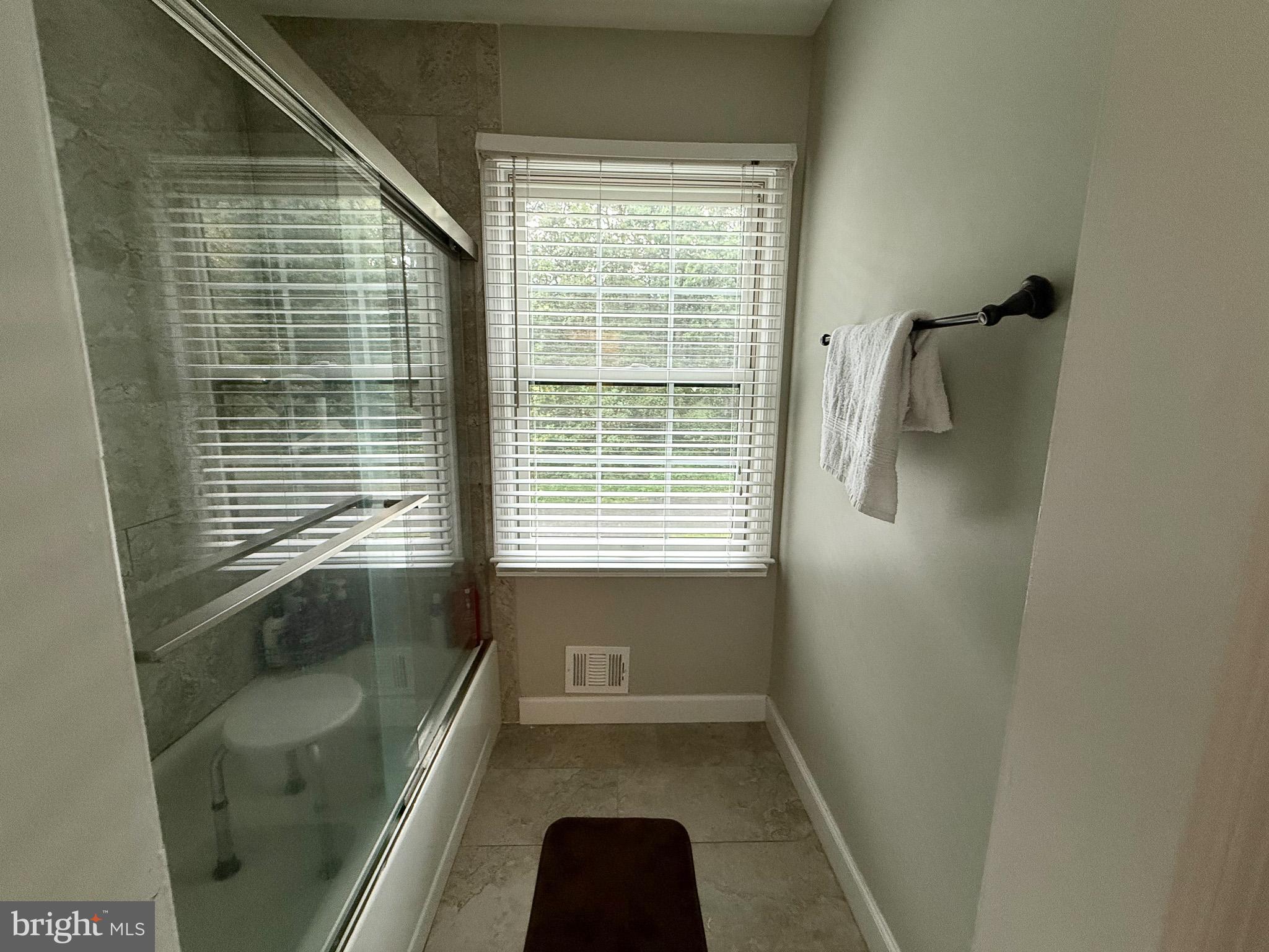 6421 Spring Lake Drive Burke, VA 22015 - Photo 61 of 65 a bathroom with a bathtub and a shower
