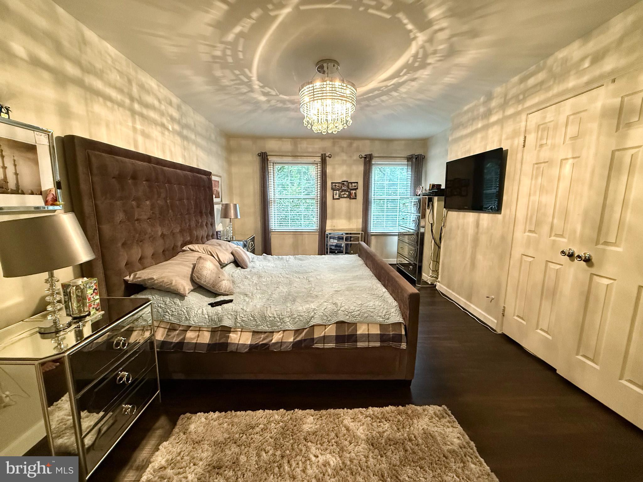 6421 Spring Lake Drive Burke, VA 22015 - Photo 63 of 65 a bed sitting in a bedroom next to a window with a flat screen tv