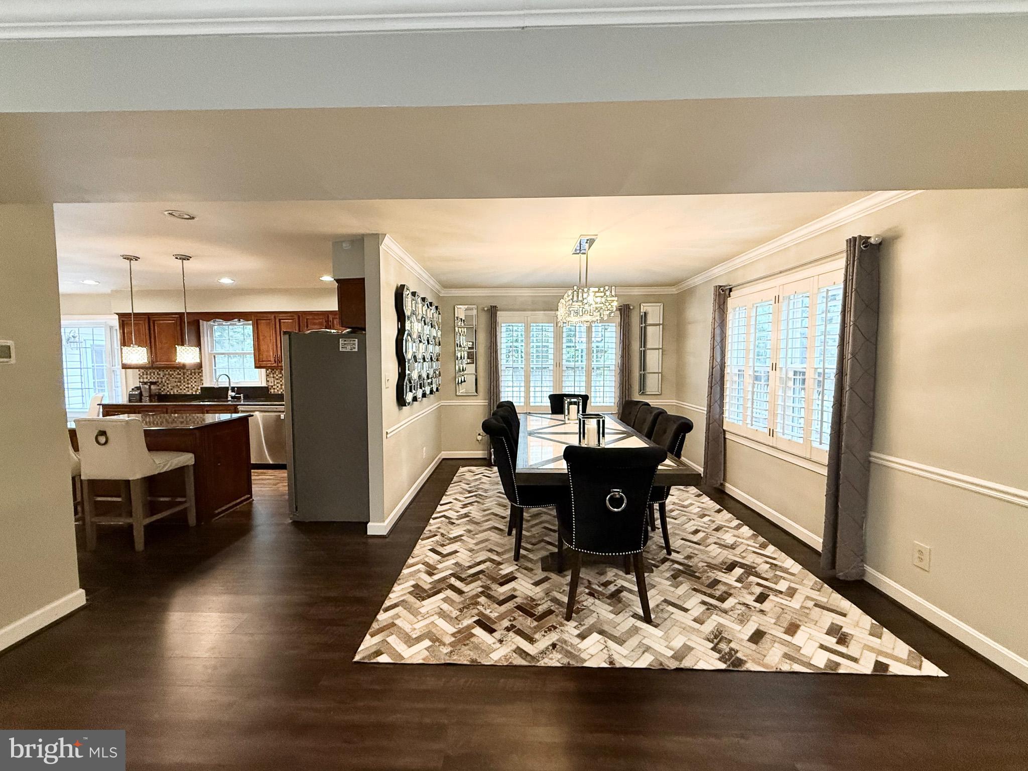 6421 Spring Lake Drive Burke, VA 22015 - Photo 7 of 65 a living room with dining table and a refrigerator