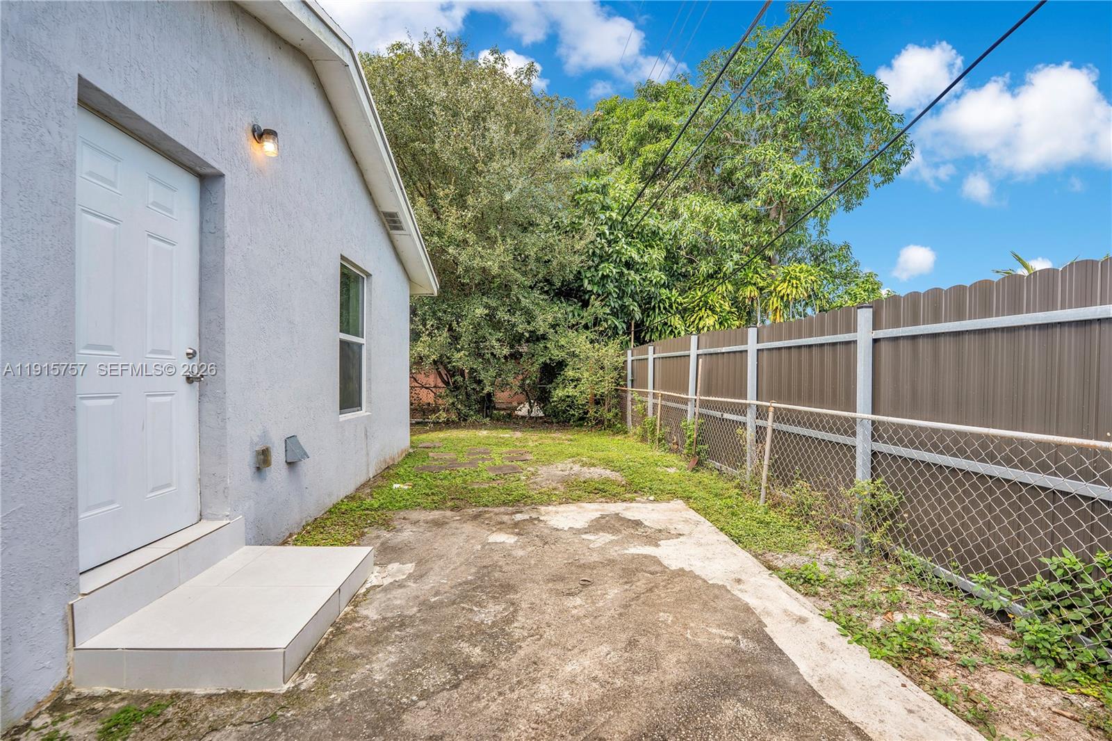 827 Northwest 114th Street Miami, FL 33168 - Photo 17 of 23 a backyard of a house with plants and large tree
