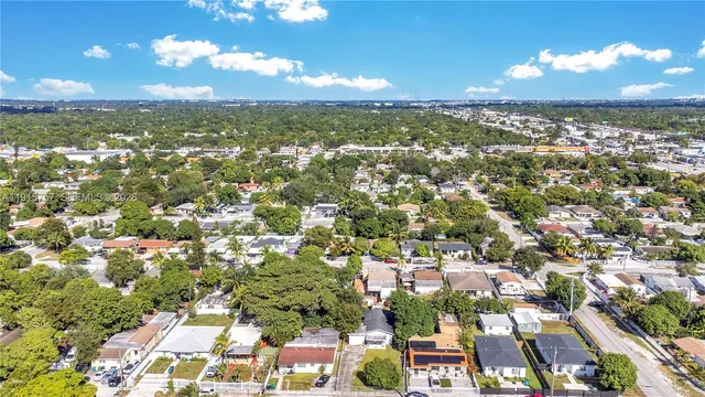 an aerial view of residential houses with city view