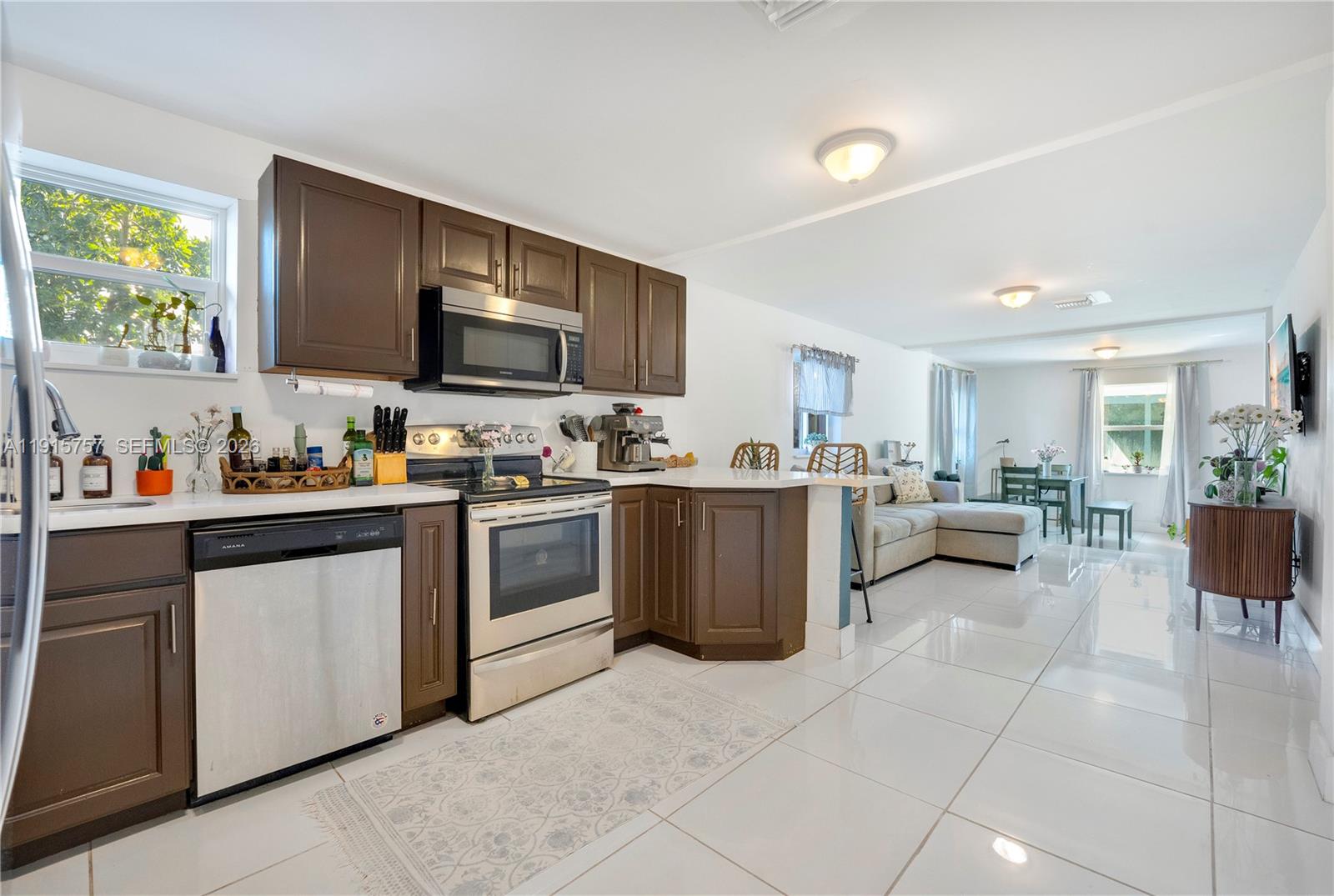 827 Northwest 114th Street Miami, FL 33168 - Photo 7 of 23 a kitchen with a sink a counter top space appliances and cabinets