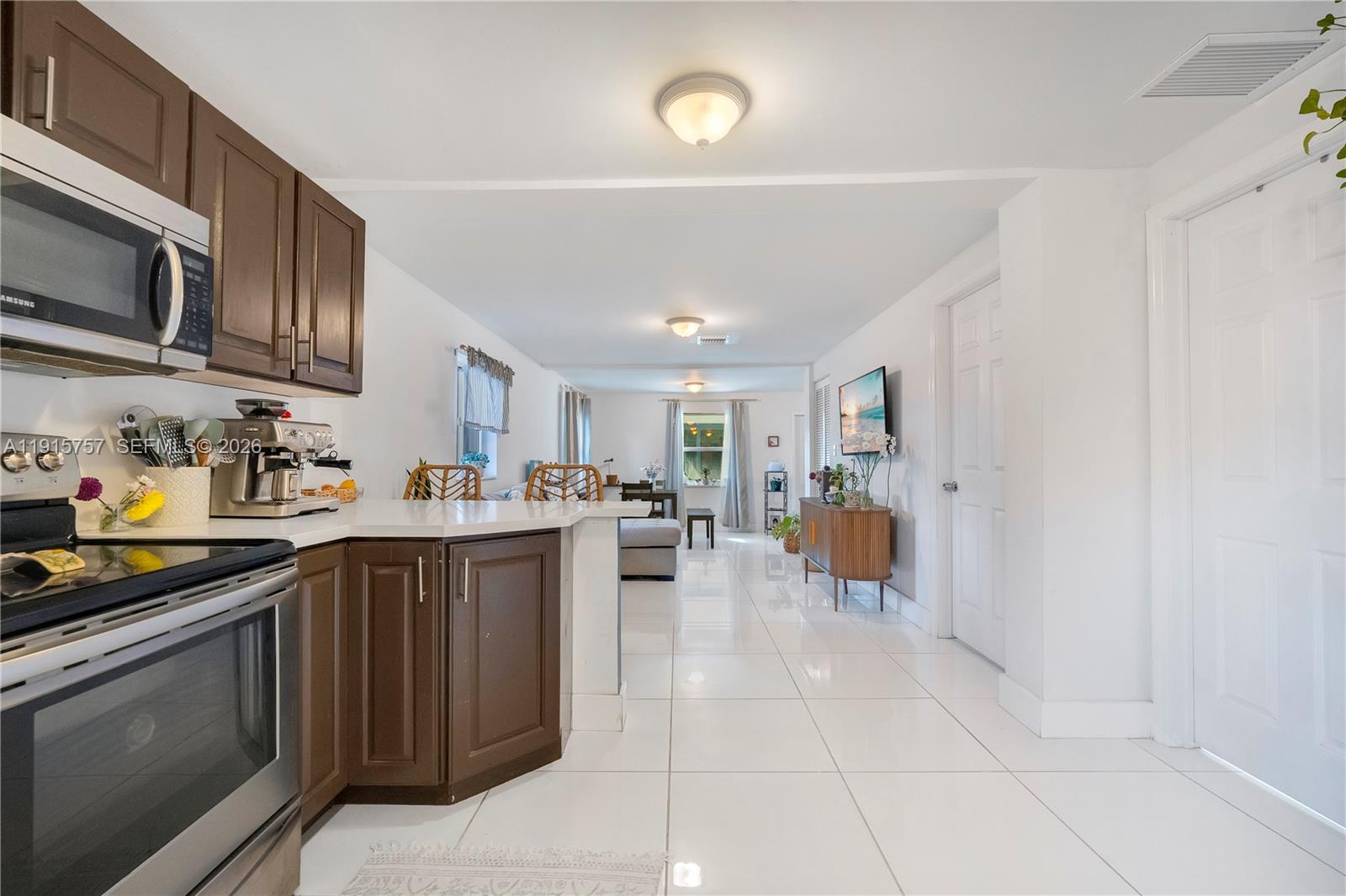 827 Northwest 114th Street Miami, FL 33168 - Photo 9 of 23 a kitchen with stainless steel appliances granite countertop a stove top oven a sink dishwasher and cabinets