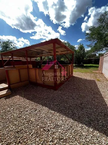 a view of a backyard with large trees