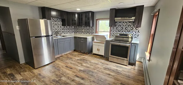 a kitchen with a refrigerator sink and stove