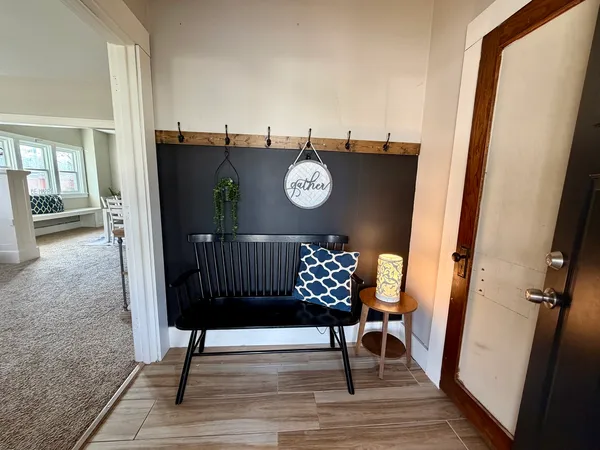 a view of a hallway with wooden floor and door