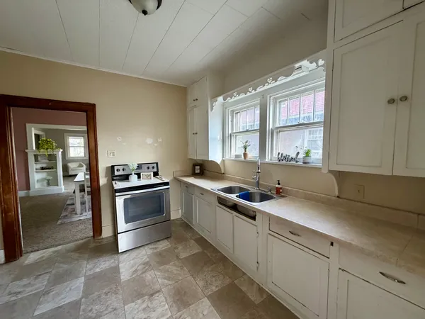 a kitchen with stainless steel appliances granite countertop a sink stove and cabinets