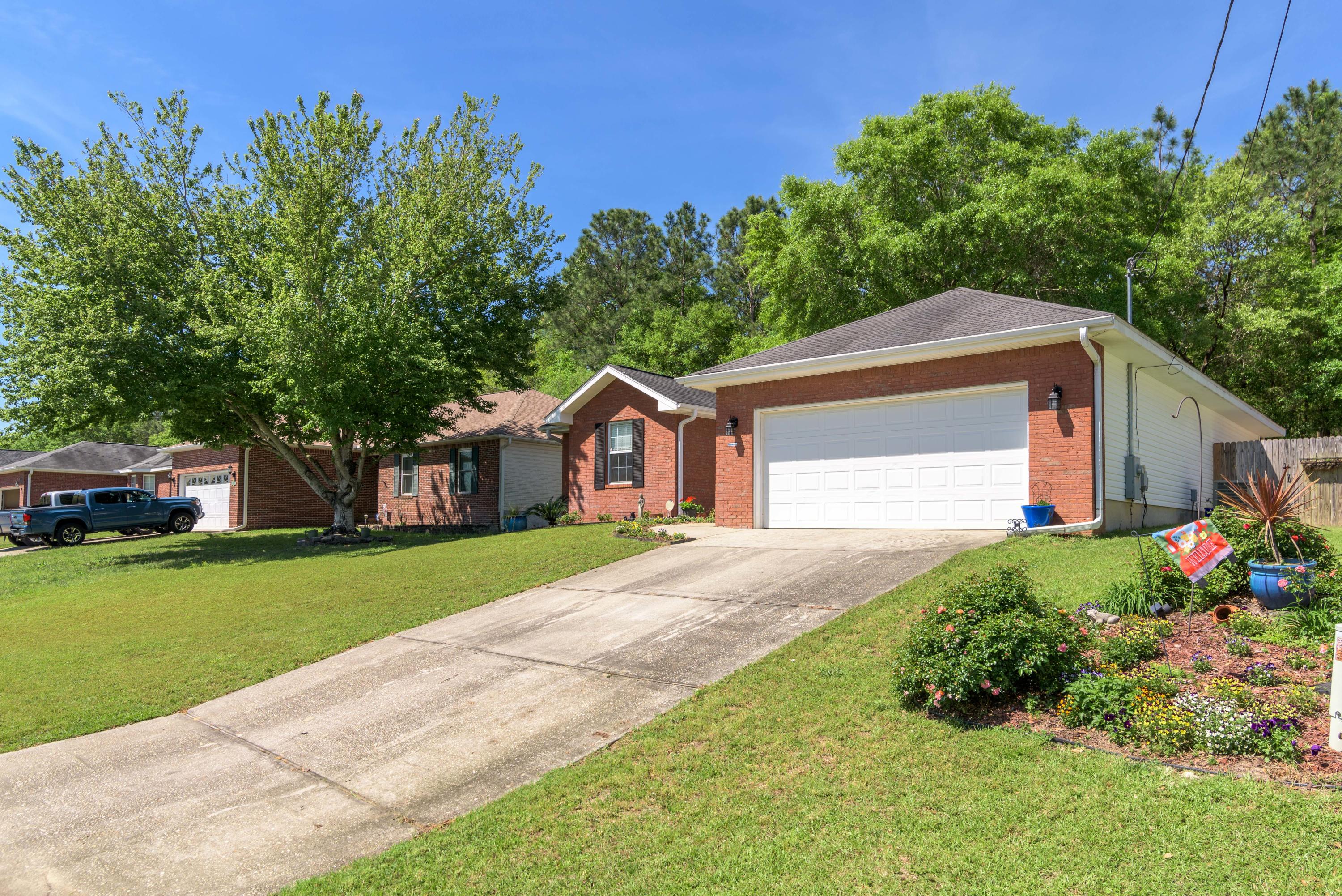 205 Tiffot Court Crestview, FL 32539 - Photo 1 of 32 a front view of a house with garden