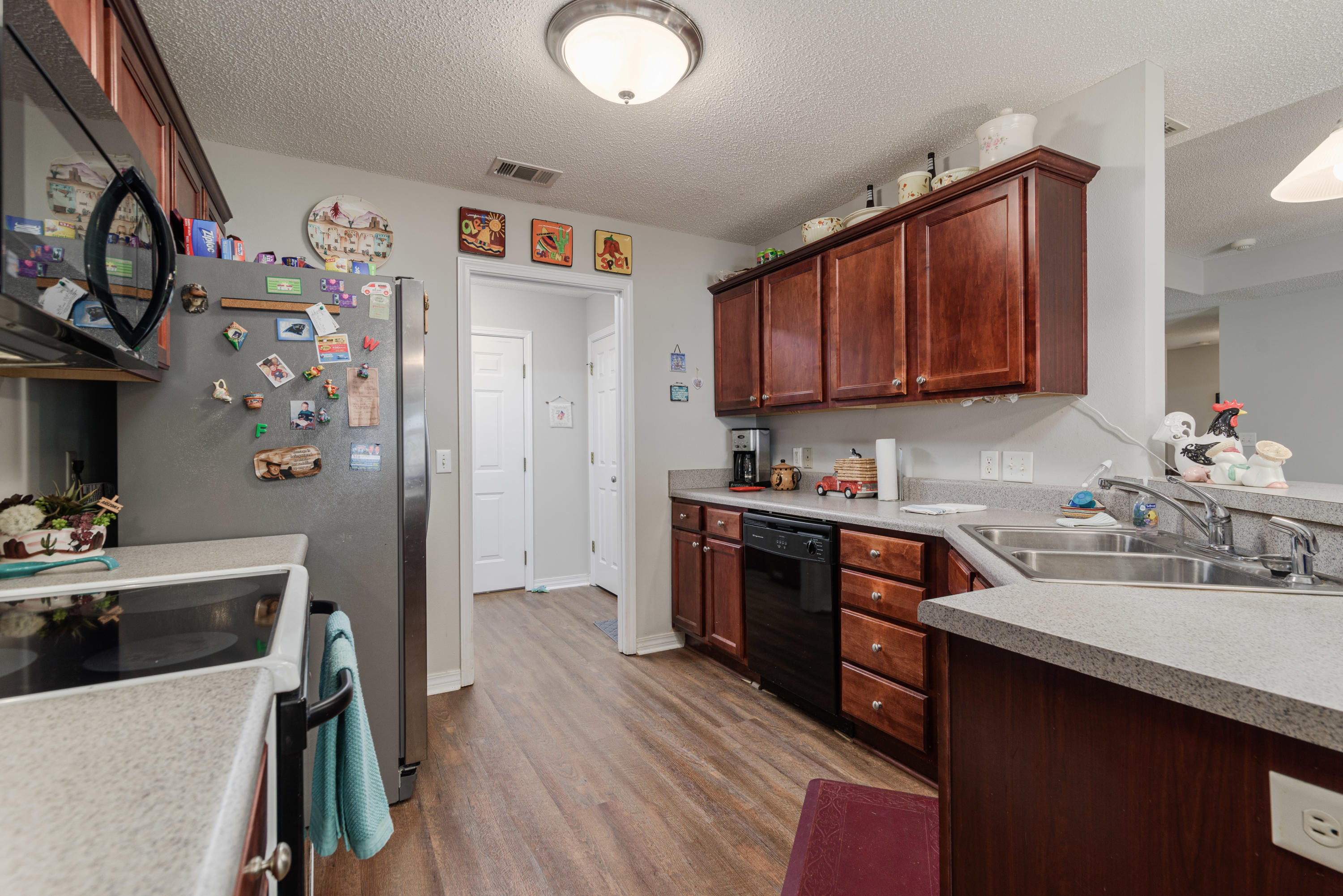 205 Tiffot Court Crestview, FL 32539 - Photo 11 of 32 a kitchen with stainless steel appliances a sink a stove a refrigerator and cabinets