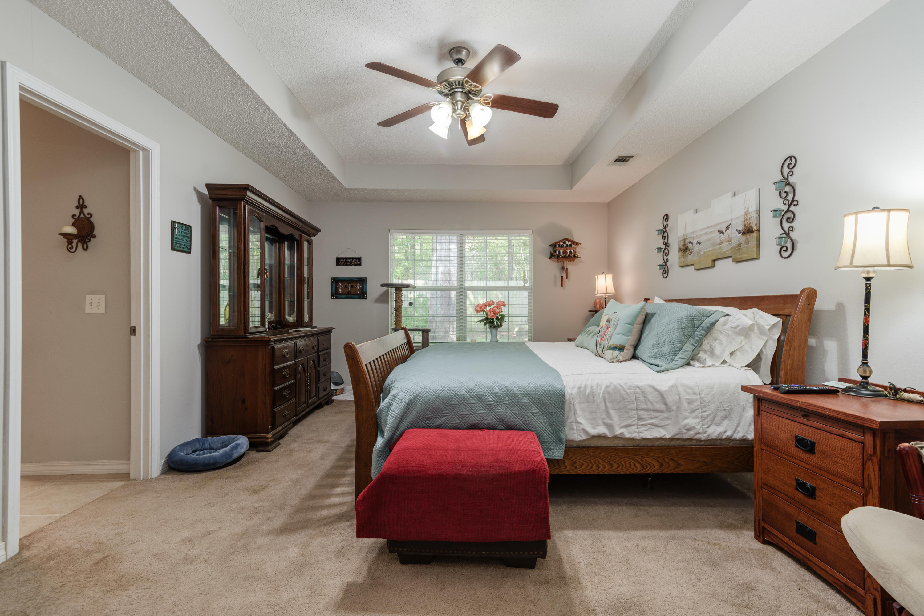 205 Tiffot Court Crestview, FL 32539 - Photo 15 of 32 a bedroom with a bed and a chandelier