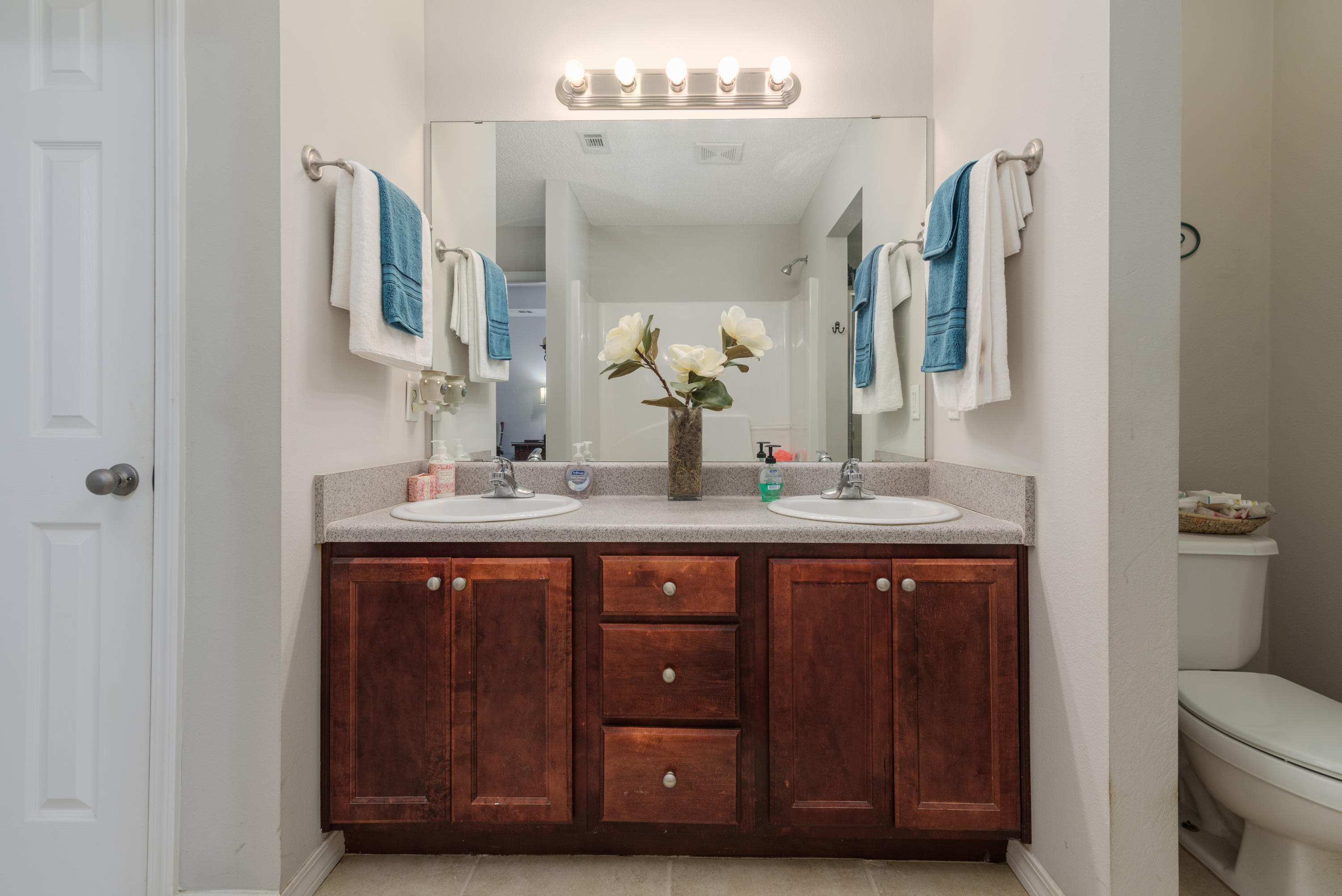 205 Tiffot Court Crestview, FL 32539 - Photo 19 of 32 a bathroom with a double vanity sink and a mirror