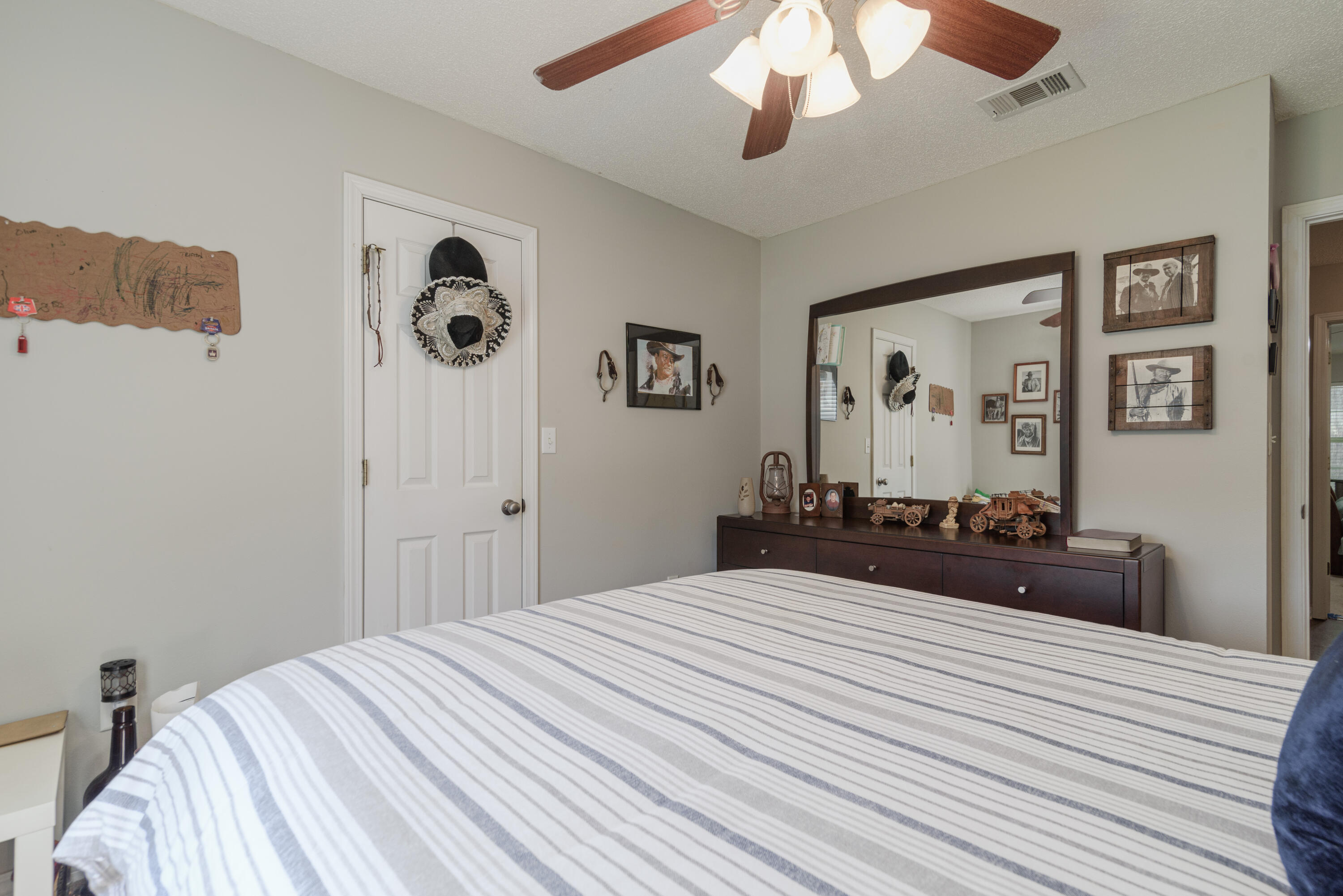 205 Tiffot Court Crestview, FL 32539 - Photo 23 of 32 a bedroom with a bed and a chandelier