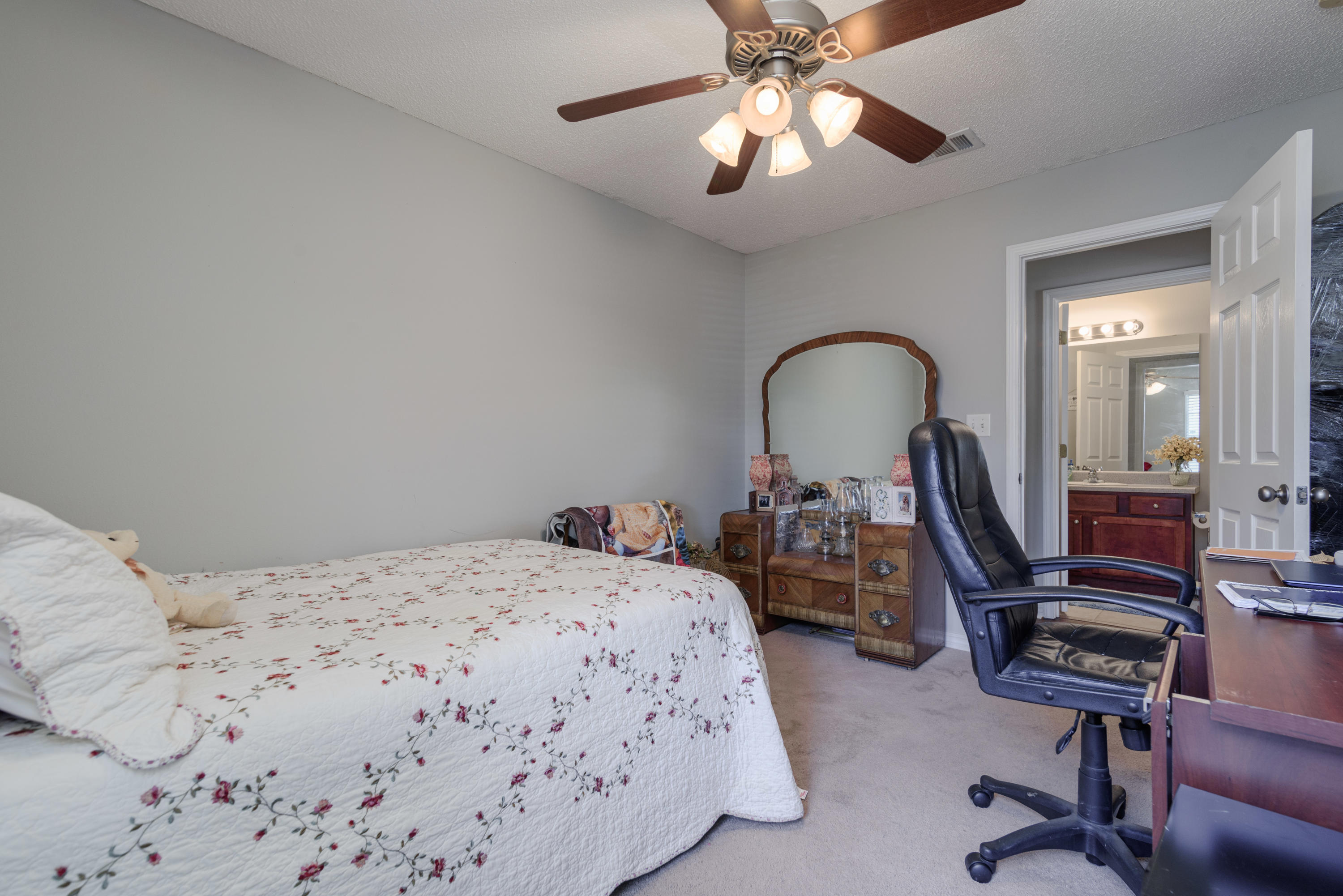205 Tiffot Court Crestview, FL 32539 - Photo 28 of 32 a bedroom with a bed and a chandelier