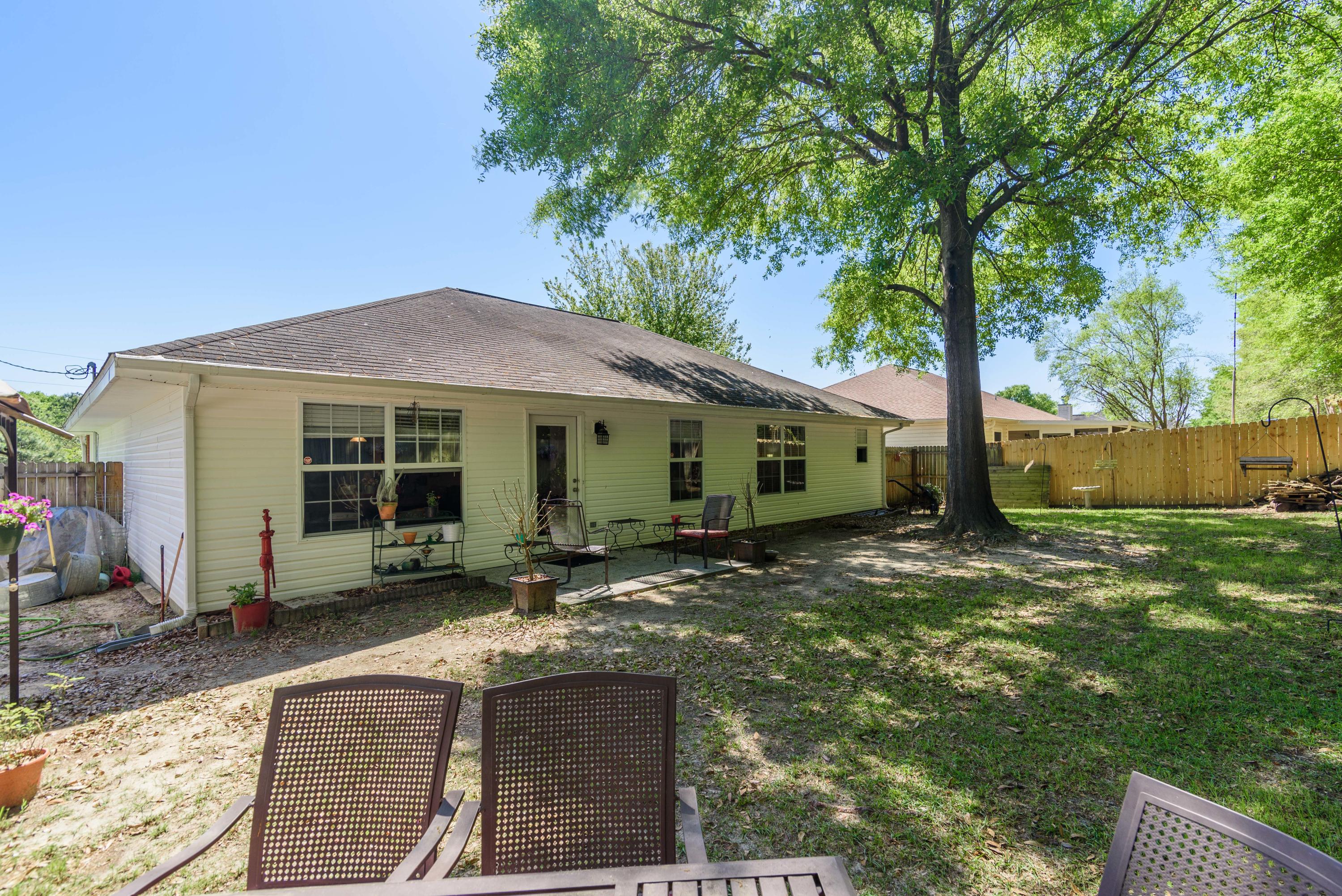 205 Tiffot Court Crestview, FL 32539 - Photo 31 of 32 a view of a house with backyard sitting area and garden