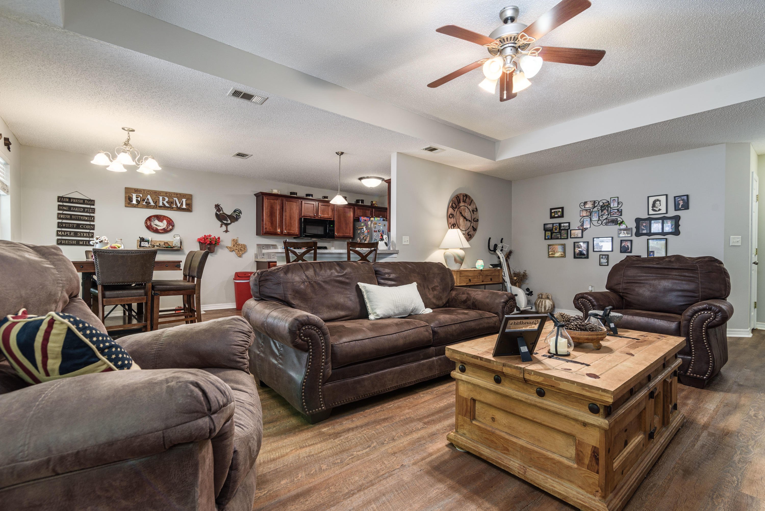 205 Tiffot Court Crestview, FL 32539 - Photo 7 of 32 a living room with furniture a chandelier and a flat screen tv