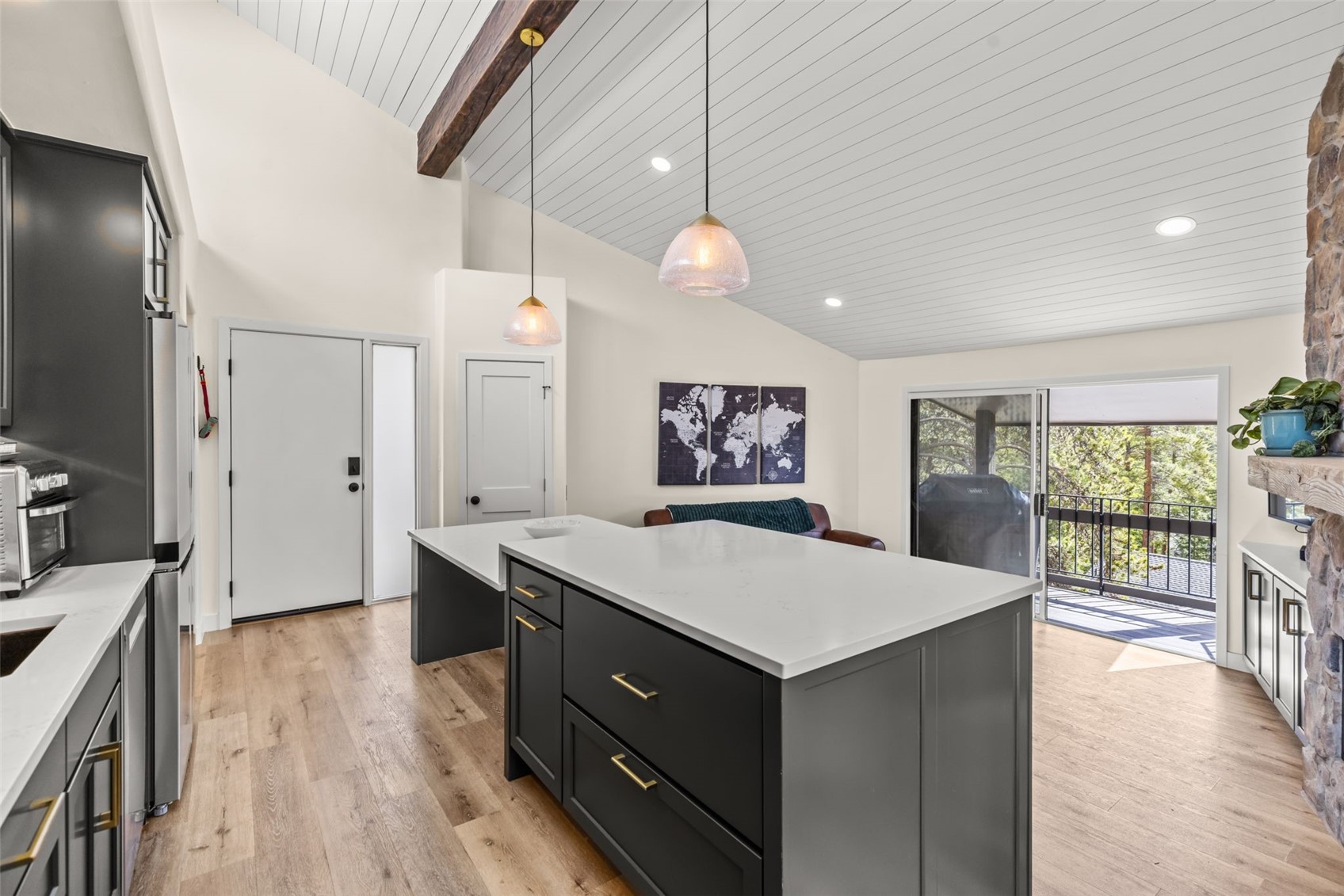 1127 Ski Hill Road, Unit 104 Breckenridge, CO 80424 - Photo 13 of 32 a hall with kitchen island white cabinets and wooden floor