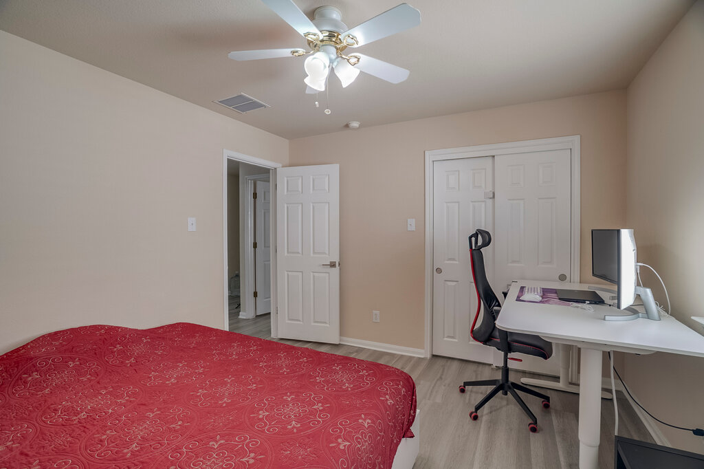 2724 Kickapoo Cavern Drive Pflugerville, TX 78660 - Photo 18 of 24 A versatile space features a comfortable sleeping area and a dedicated workstation.