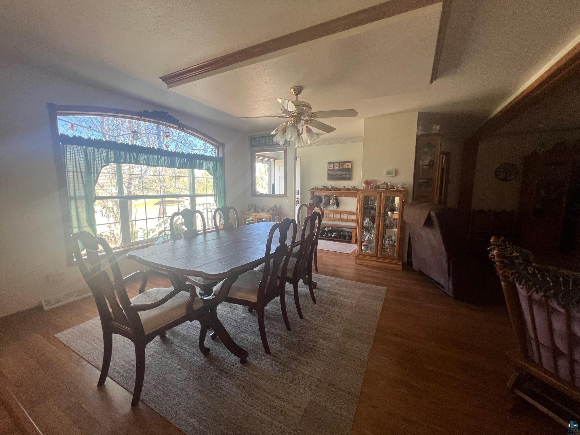 350 Freeman Road Cloquet, MN 55720 - Photo 8 of 27 Dining space with a textured ceiling, baseboards, wood finished floors, and a ceiling fan