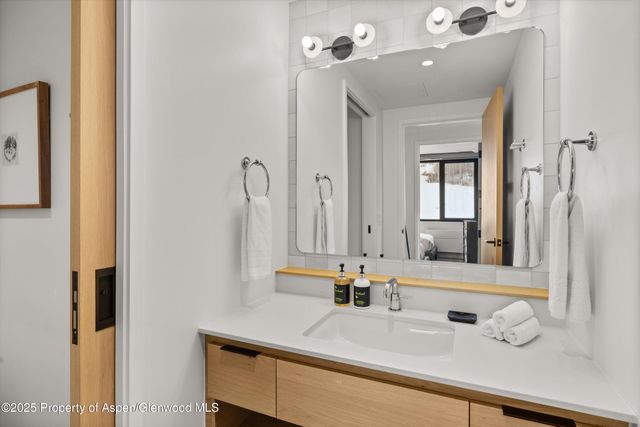 a bathroom with a sink vanity and a mirror