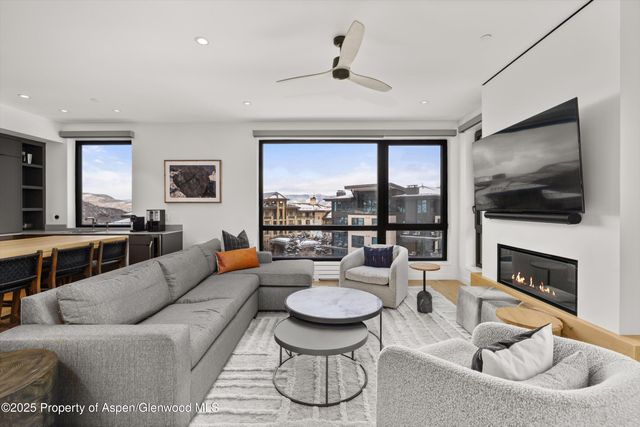 a living room with furniture fireplace and a flat screen tv