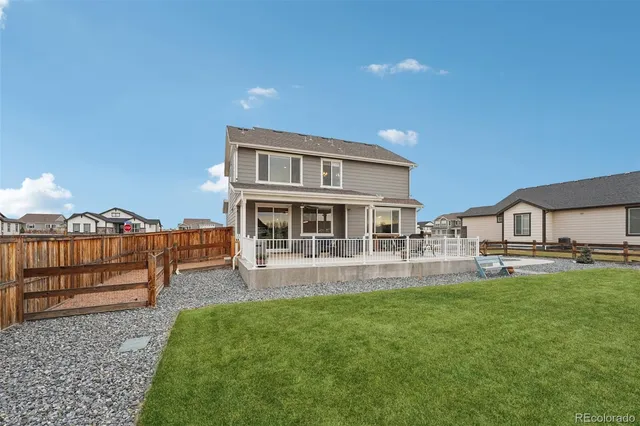 a front view of a house with a yard glass top table and chairs