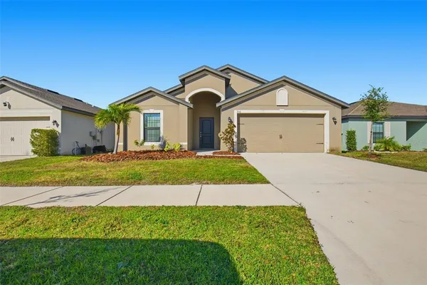 a front view of a house with a yard