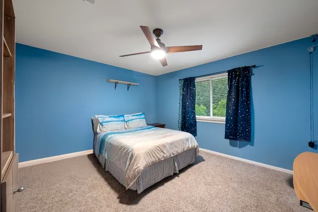 a bedroom with a bed and a window