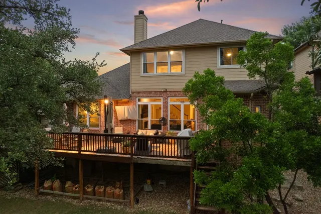 a front view of a house with balcony and garden