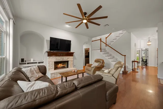 a living room with furniture a fireplace and a flat screen tv