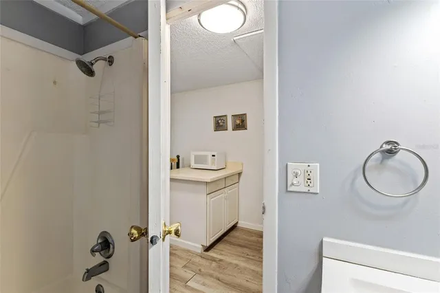 a bathroom with a granite countertop sink toilet and shower