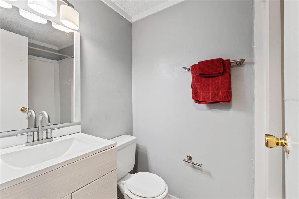 2490 Southwest 14th Drive, Unit 23 Gainesville, FL 32608 - Photo 10 of 14 a bathroom with a toilet sink and mirror