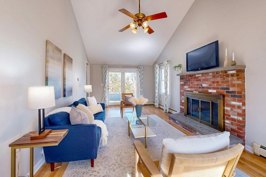 1 Hodge Road Arlington, MA 02474 - Photo 14 of 39 a living room with furniture a flat screen tv and a fireplace