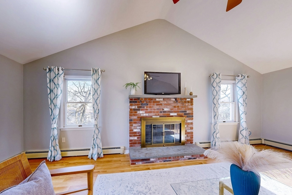 1 Hodge Road Arlington, MA 02474 - Photo 15 of 39 a living room with furniture flat screen tv and a fireplace