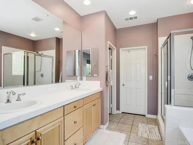 a bathroom with a sink double vanity and a mirror