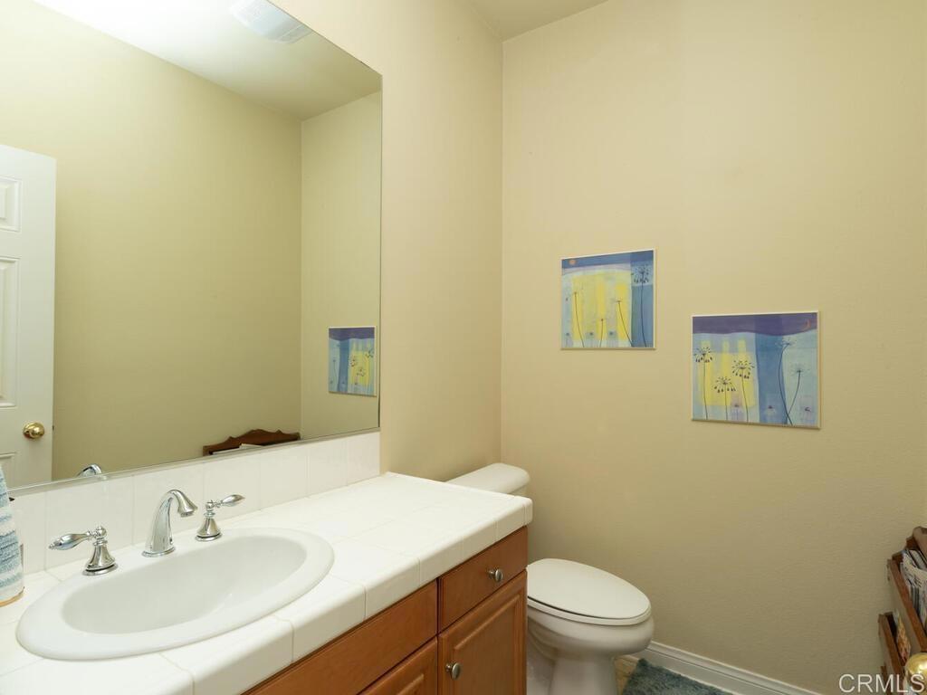 190 Mission Oaks Road Fallbrook, CA 92028 - Photo 28 of 50 a bathroom with a sink a toilet and mirror