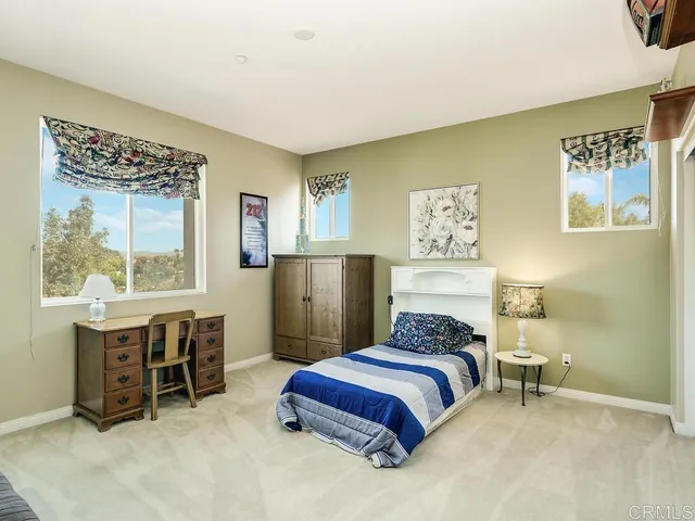 a bedroom with a bed and a table in it