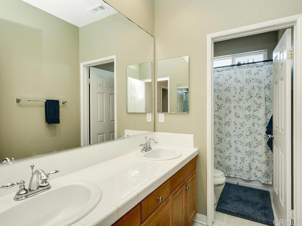 190 Mission Oaks Road Fallbrook, CA 92028 - Photo 32 of 50 a bathroom with a sink and a mirror