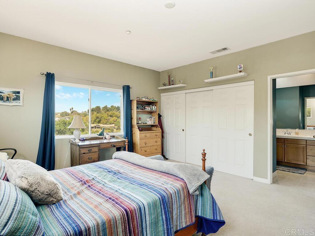190 Mission Oaks Road Fallbrook, CA 92028 - Photo 34 of 50 a bedroom with a large bed and a large window