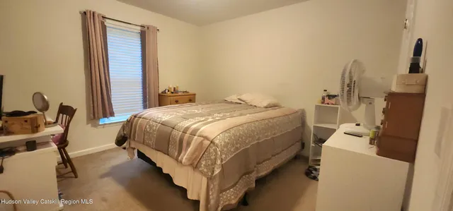 a bed sitting in a room next to a window