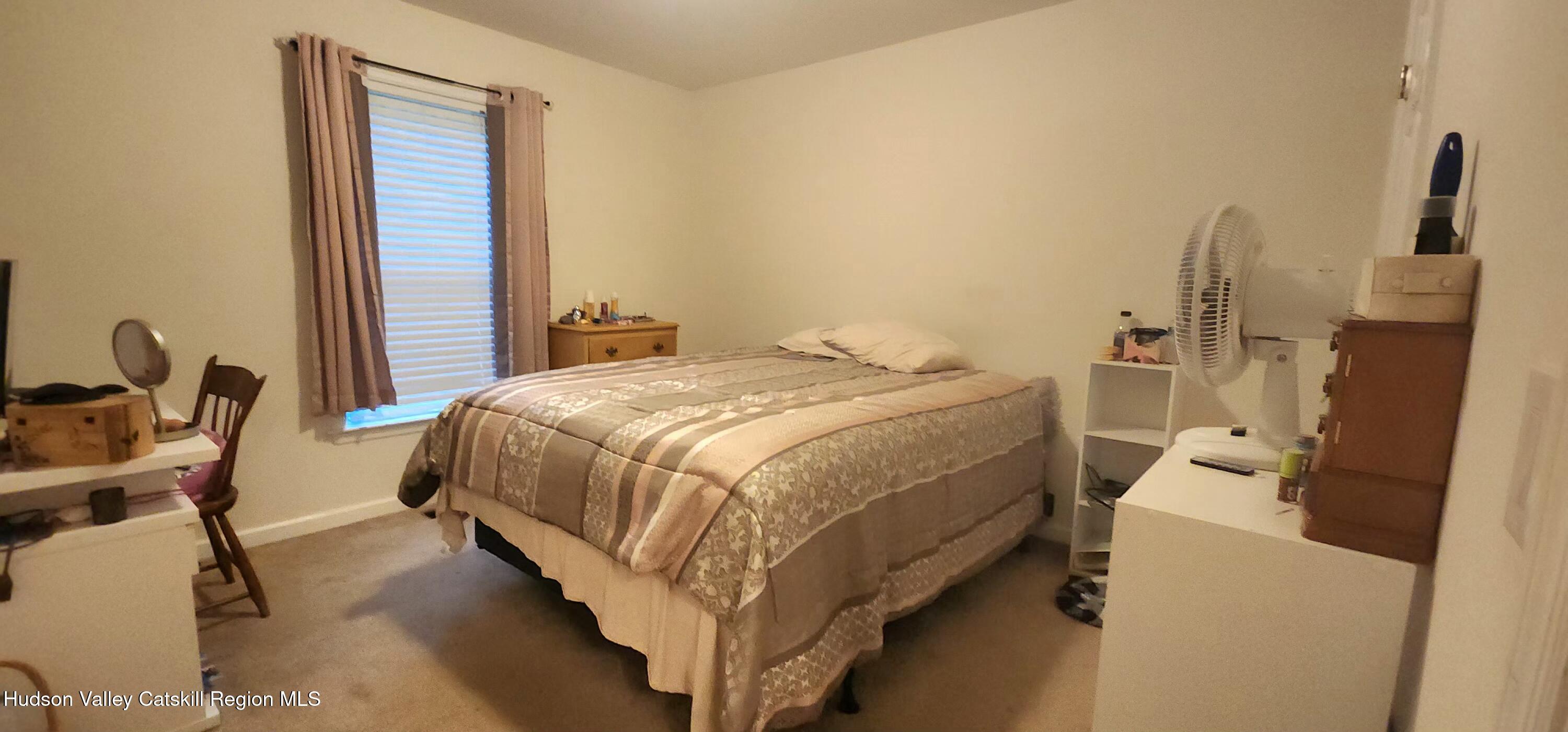 89 Zinno Road Ashland, NY 12496 - Photo 16 of 37 a bed sitting in a room next to a window