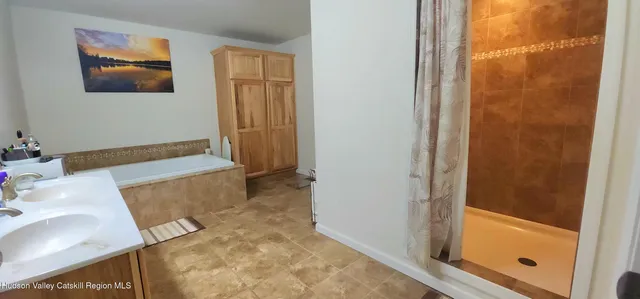 a bathroom with a tub and a sink