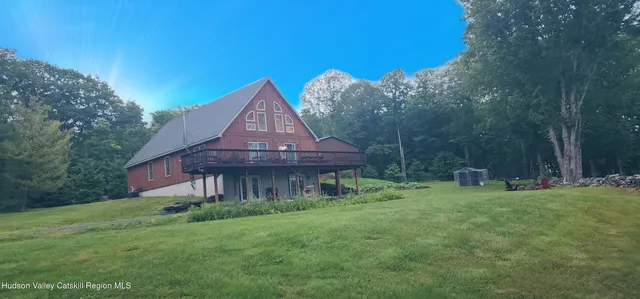 a backyard of a house with table and chairs