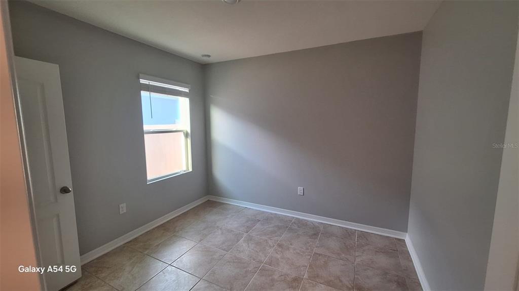 754 Chinoy Road Davenport, FL 33837 - Photo 4 of 26 a view of an empty room with a window
