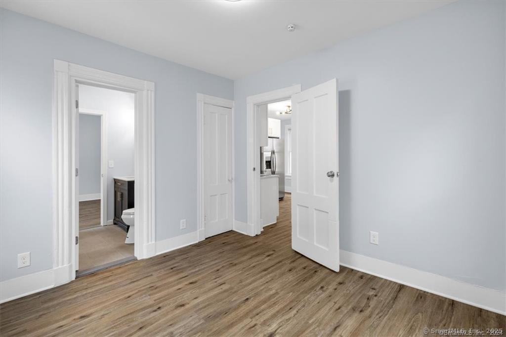 55 Admiral Street, Unit 2 New Haven, CT 06511 - Photo 12 of 35 a view of an empty room with wooden floor and a bathroom